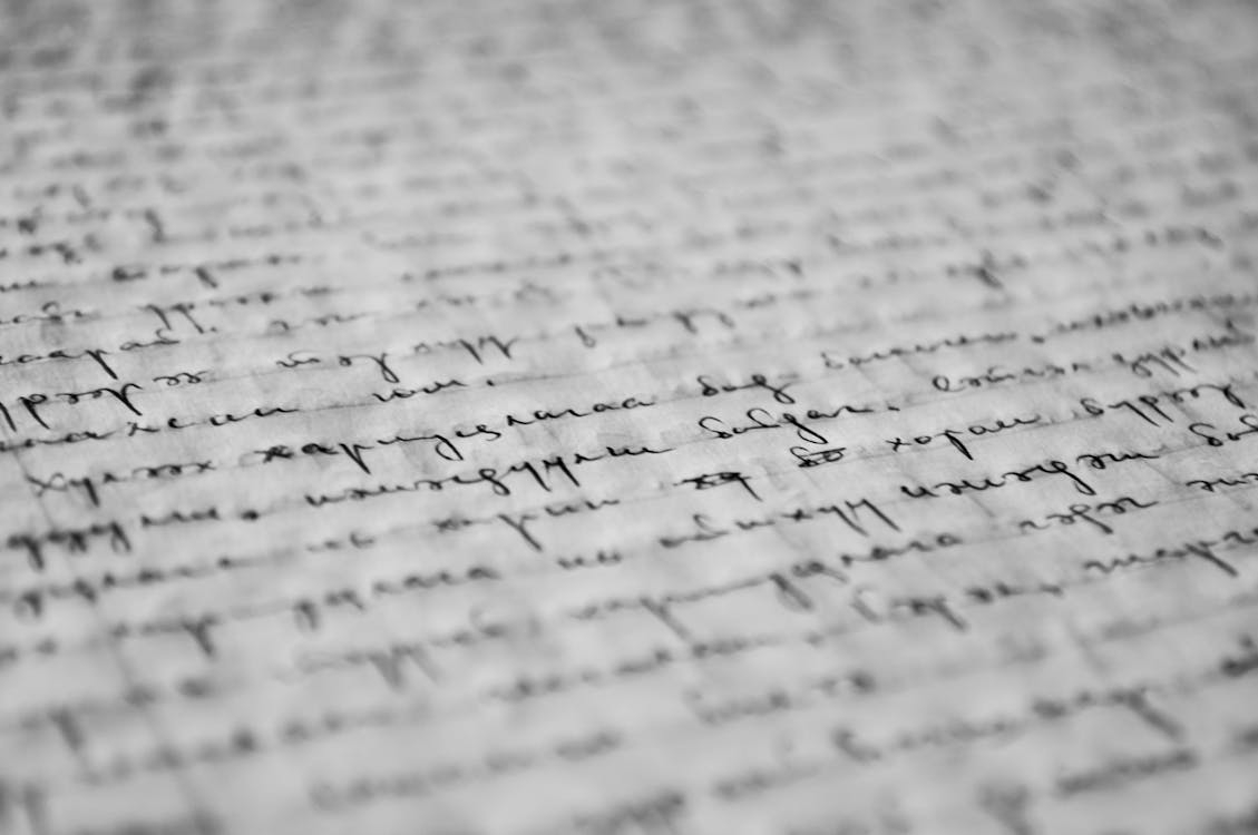 Writer at a laptop comparing two documents